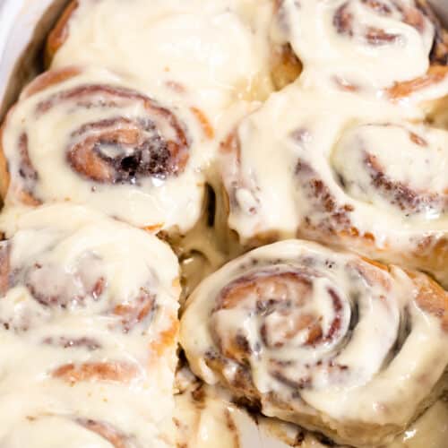 the best no knead cinnamon rolls in the pan with frosting