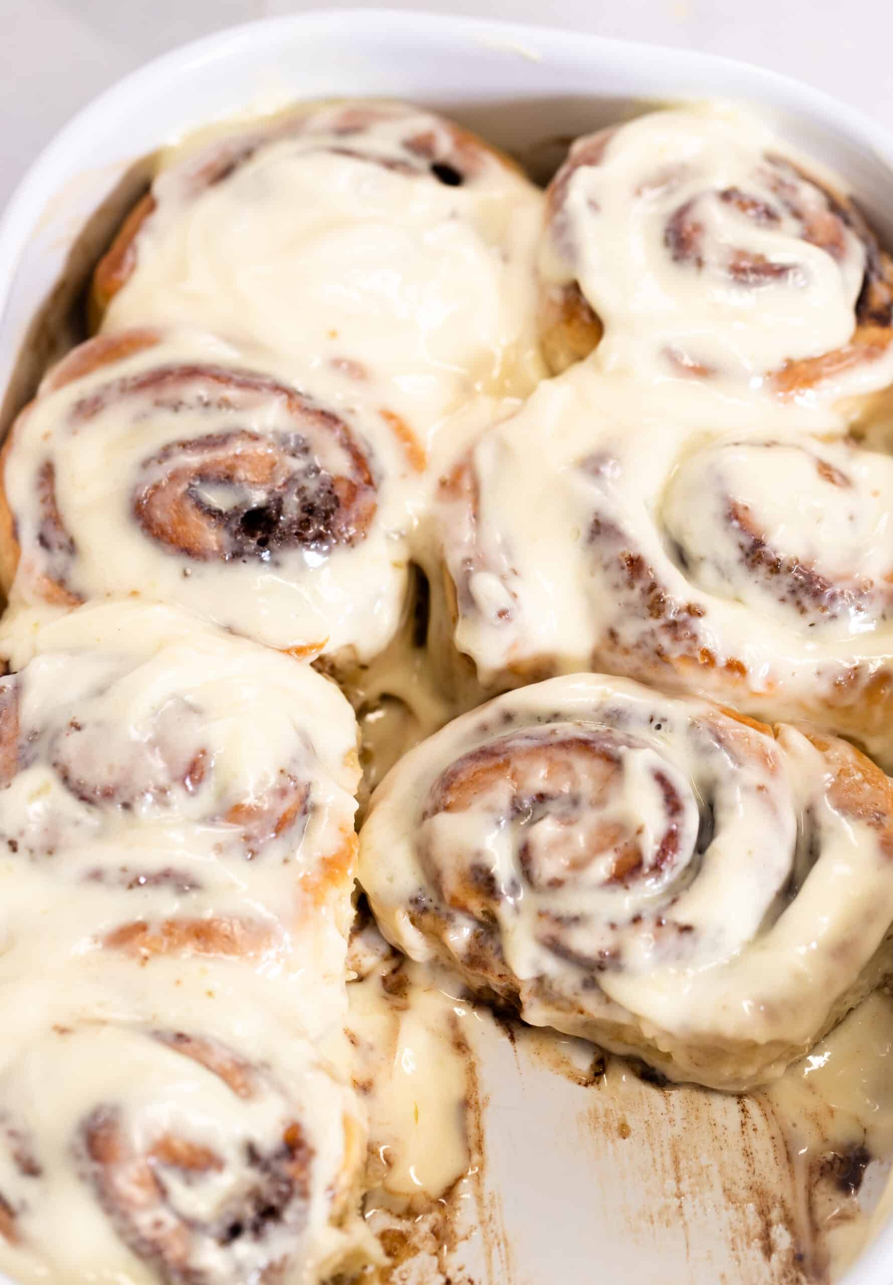 the best no knead cinnamon rolls in the pan with frosting
