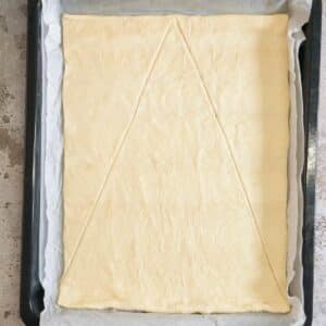 cut the pizza dough into a triangle shape