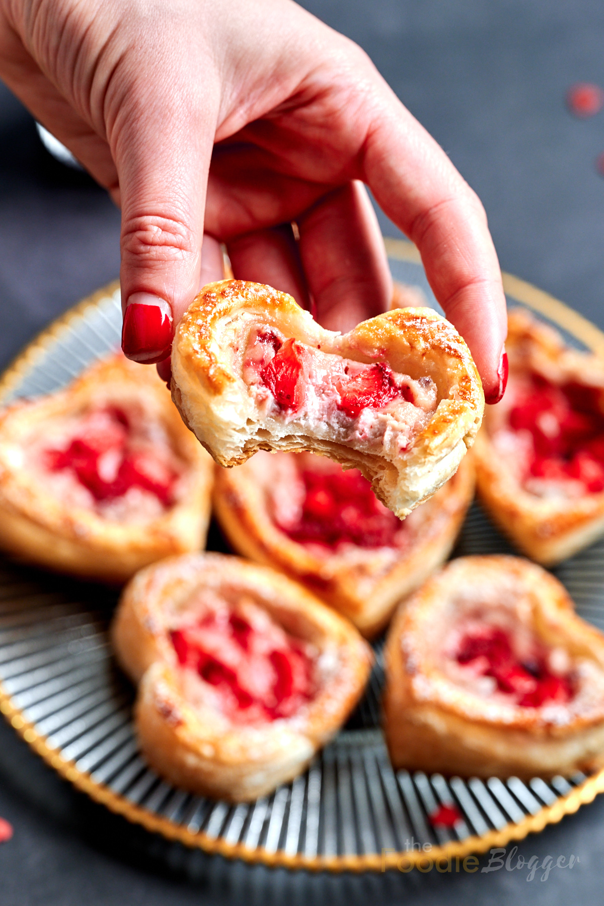 cream cheese strawberry puff pastry hold in hand to show texture and the filling