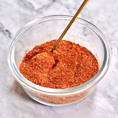 homemade taco seasoning recipe in a jar with a gold spoon