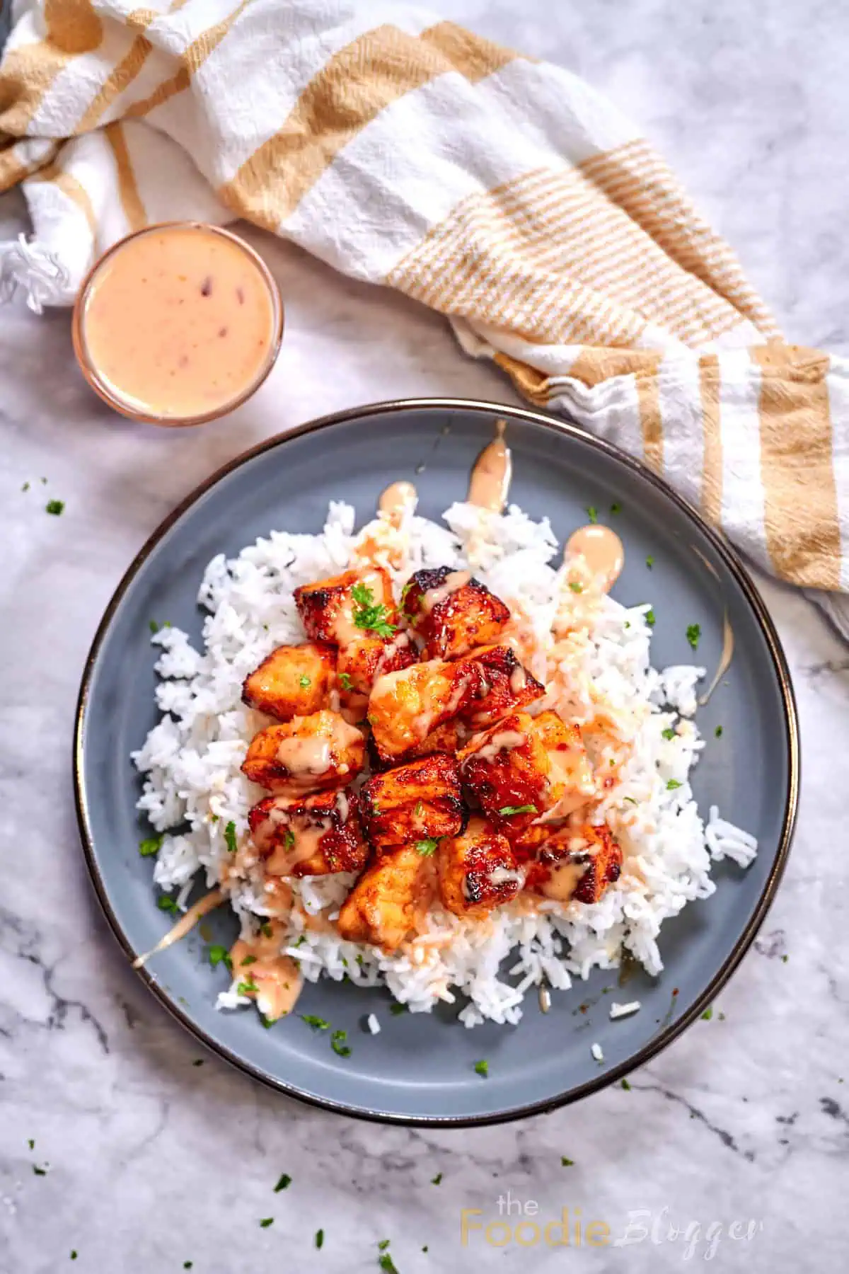 Bang Bang Salmon 2 Delicious air-fried salmon cubes coated in bang bang sauce atop a bed of white rice.