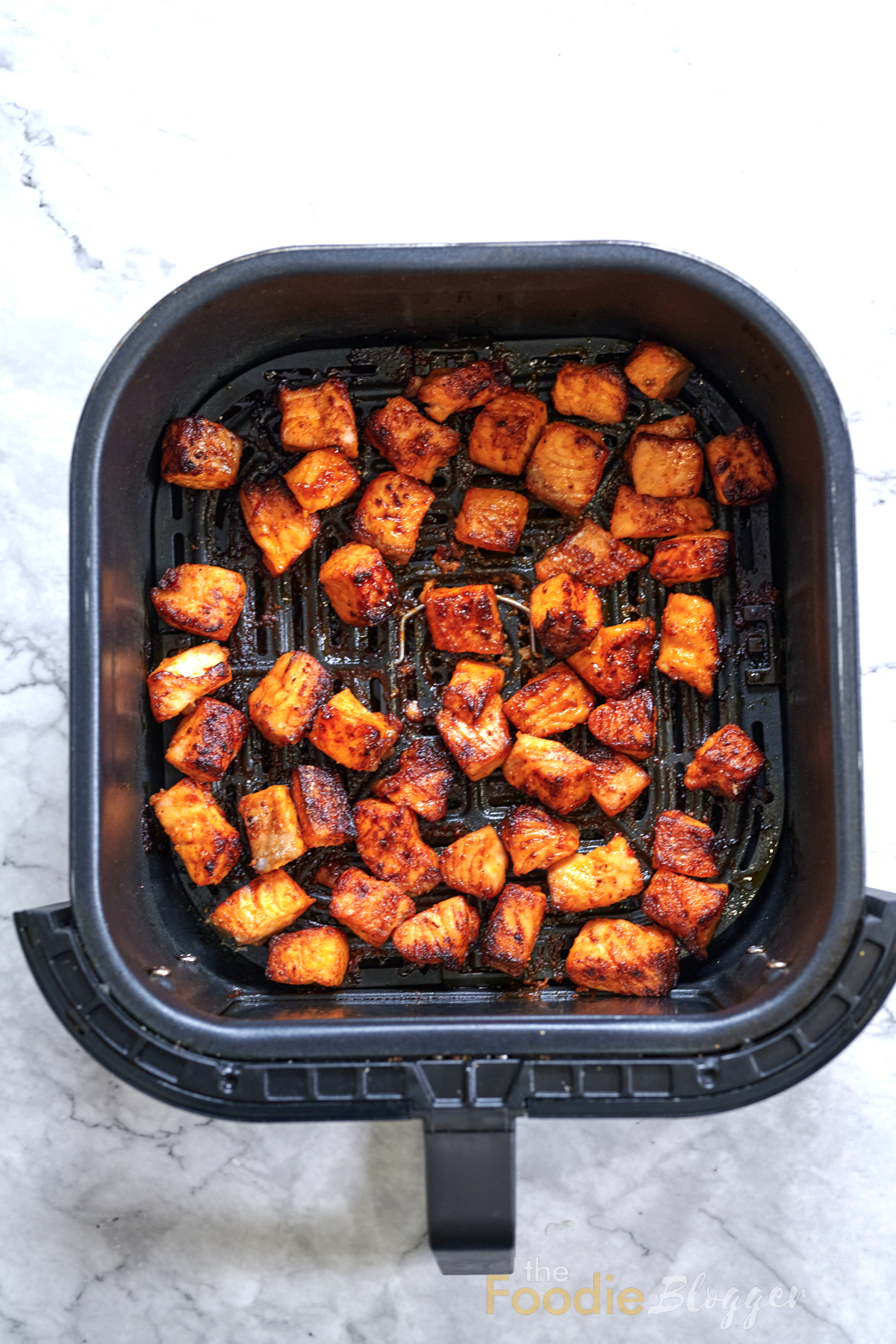 Bang Bang Salmon 8 Air-fried salmon bites golden and caramelized, freshly cooked and ready to be glazed with bang bang sauce.