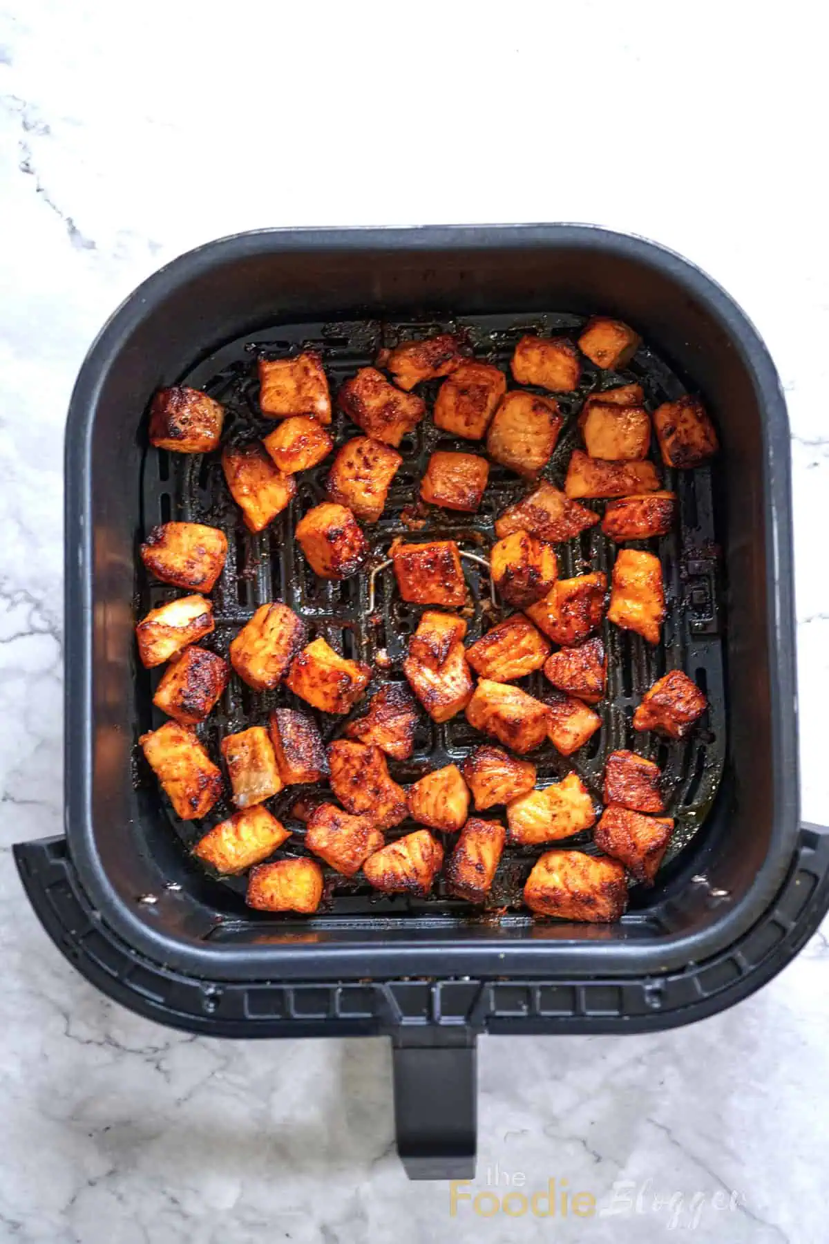 Bang Bang Salmon 8 Air-fried salmon bites golden and caramelized, freshly cooked and ready to be glazed with bang bang sauce.
