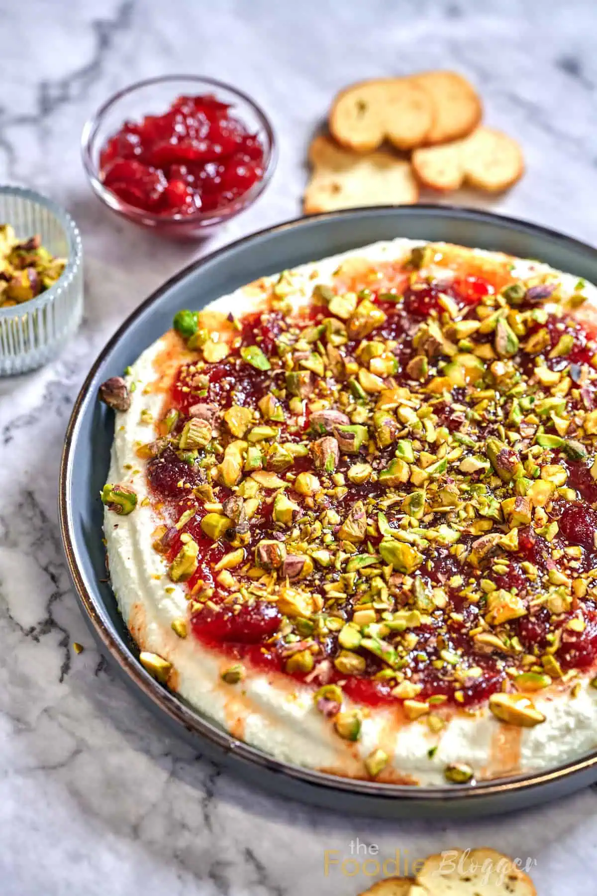 Cranberry Whipped Feta Dip 2 Whipped feta dip topped generously with cranberry sauce and crushed pistachios, perfect for gatherings.