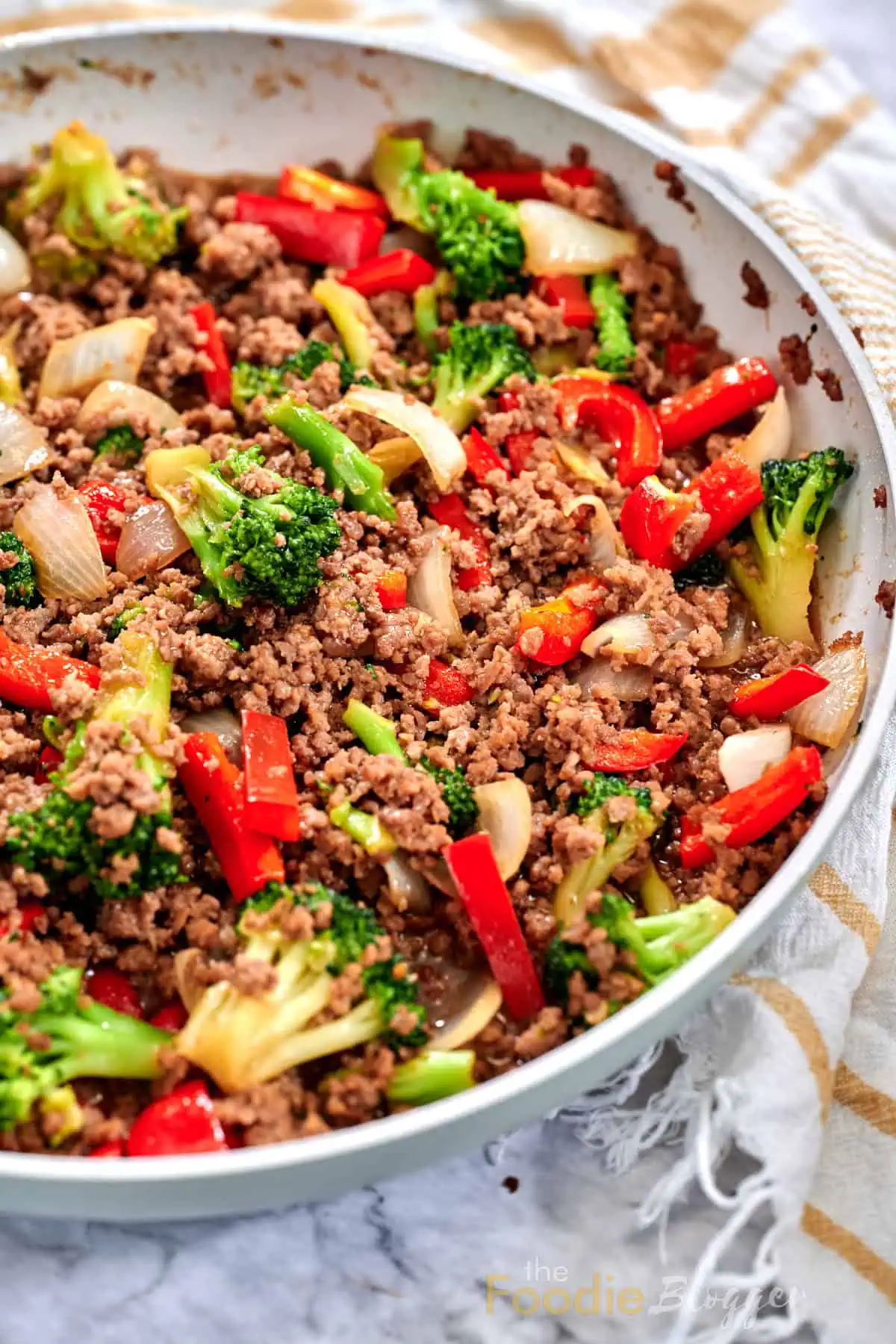 Ground Beef And Broccoli Stir Fry 5 Juicy ground beef combined with crisp broccoli and peppers inside sauté pan.