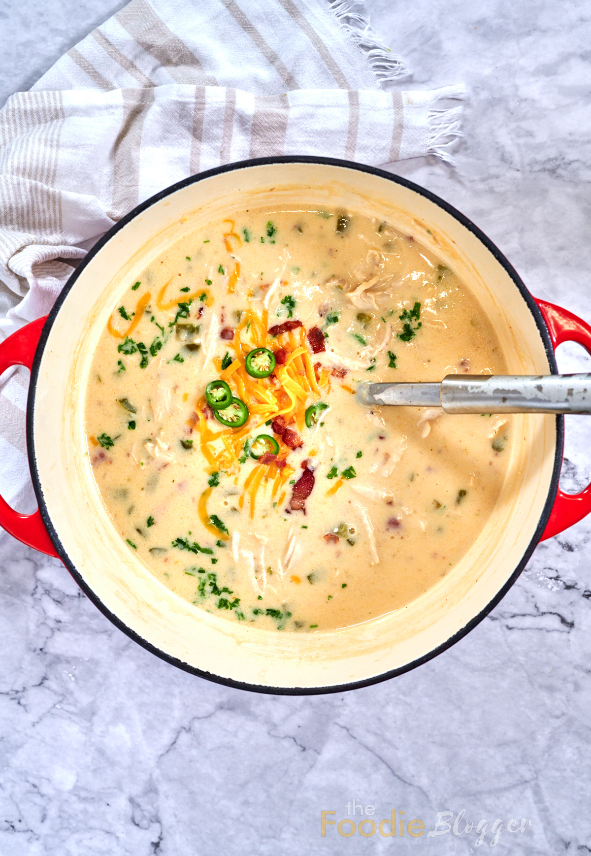 Jalapeno Popper Chicken Soup 11 Dutch oven filled with creamy jalapeño popper chicken soup, cheese and jalapeños in the center.