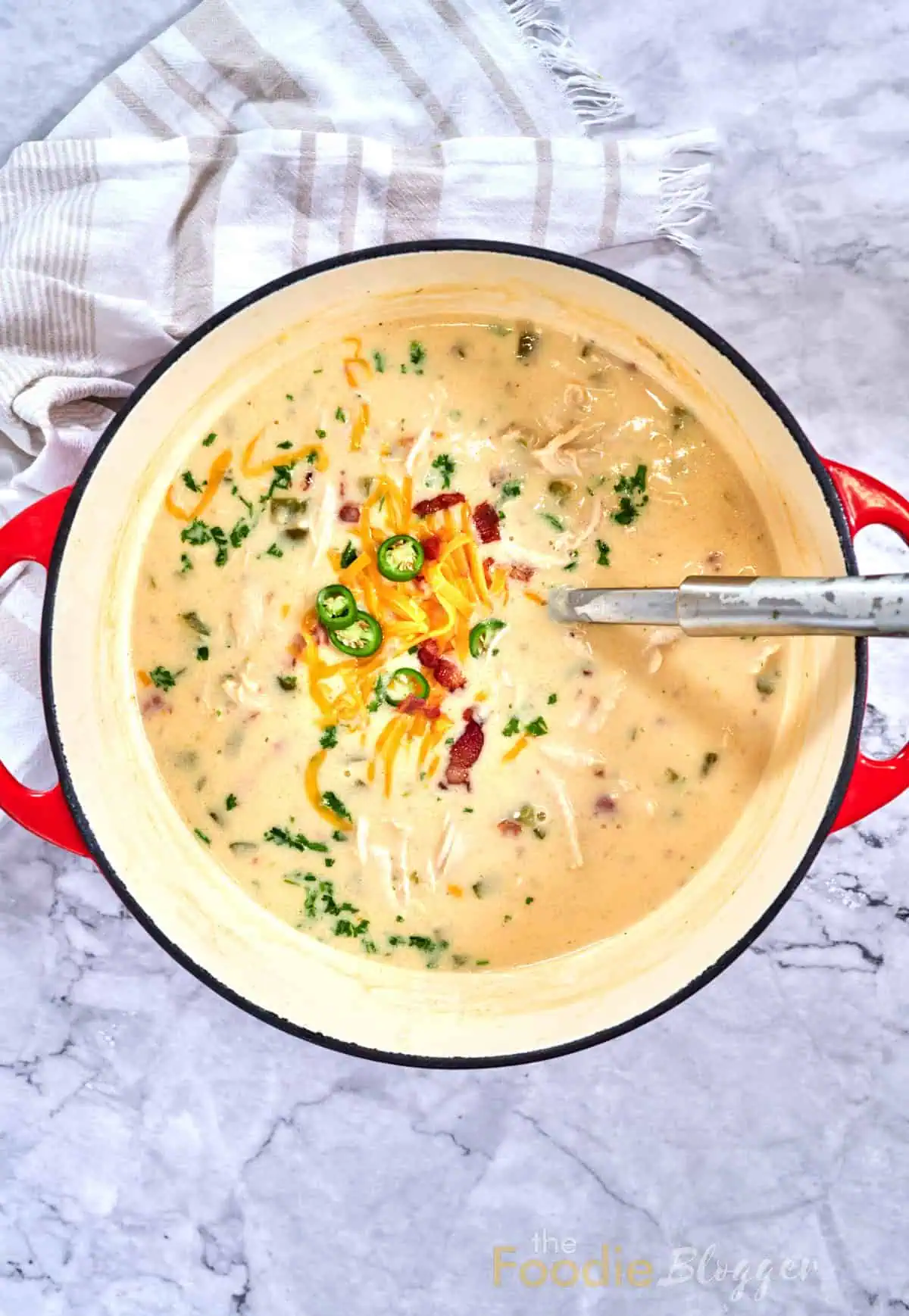 Jalapeno Popper Chicken Soup 11 Dutch oven filled with creamy jalapeño popper chicken soup, cheese and jalapeños in the center.