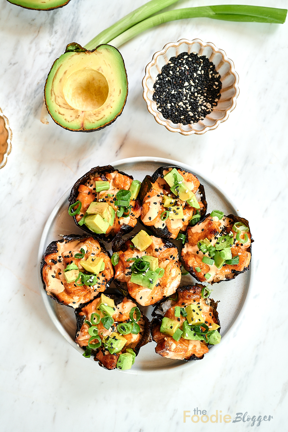 Baked Salmon Sushi Cups 11 Overhead view of baked salmon sushi cups topped with avocado and sesame seeds.