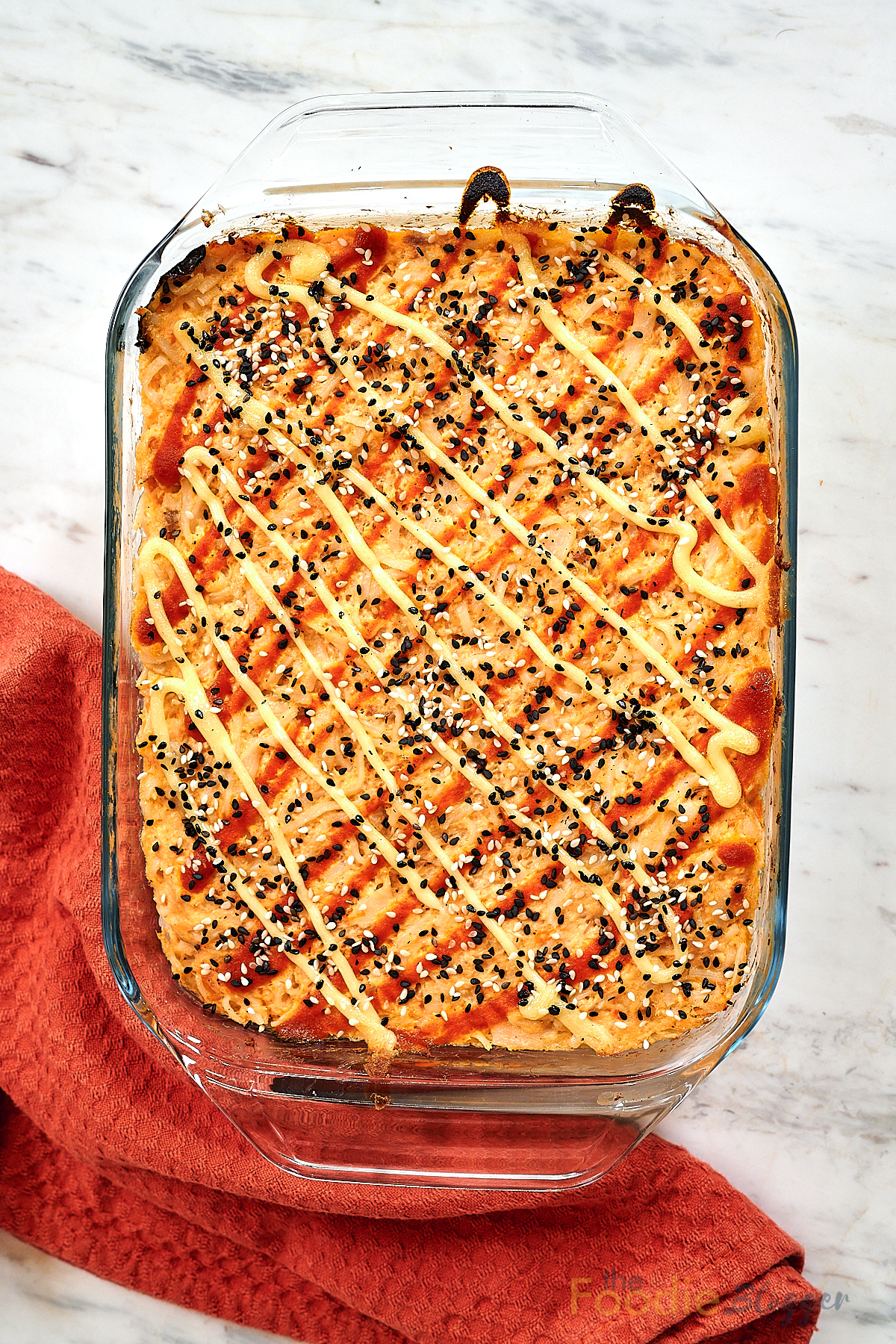Salmon Sushi Bake 2 Baked salmon sushi casserole in glass dish drizzled with spicy mayo.
