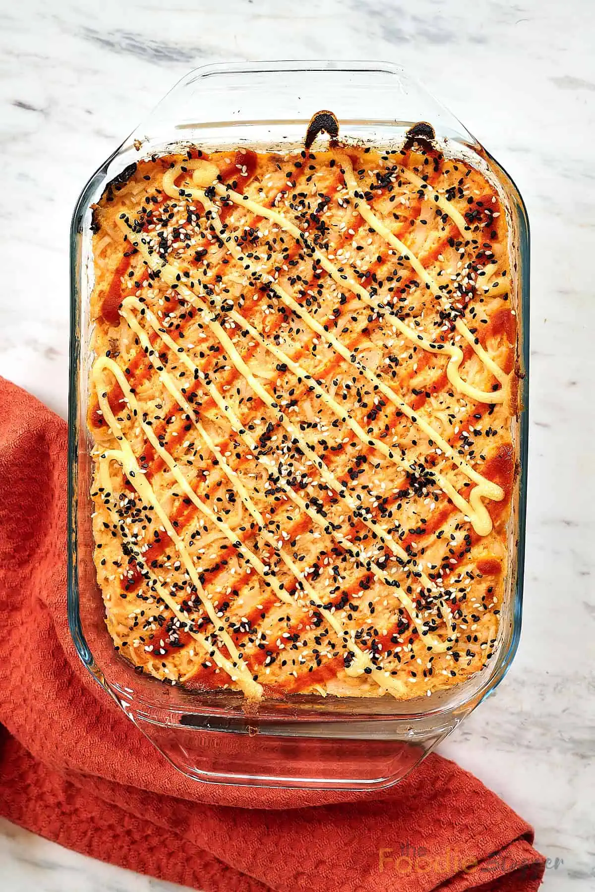 Salmon Sushi Bake 2 Baked salmon sushi casserole in glass dish drizzled with spicy mayo.