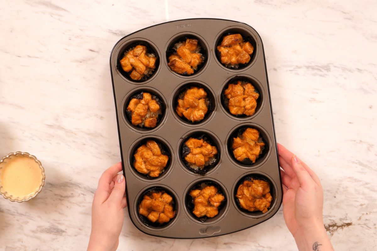 Baked Salmon Sushi Cups 9 Freshly baked salmon sushi cups in a muffin tin.