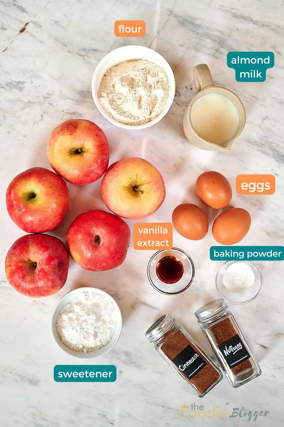 Invisible Apple Cake 3 Overhead view of invisible apple cake ingredients including apples, flour, eggs, almond milk, vanilla extract, and spices.