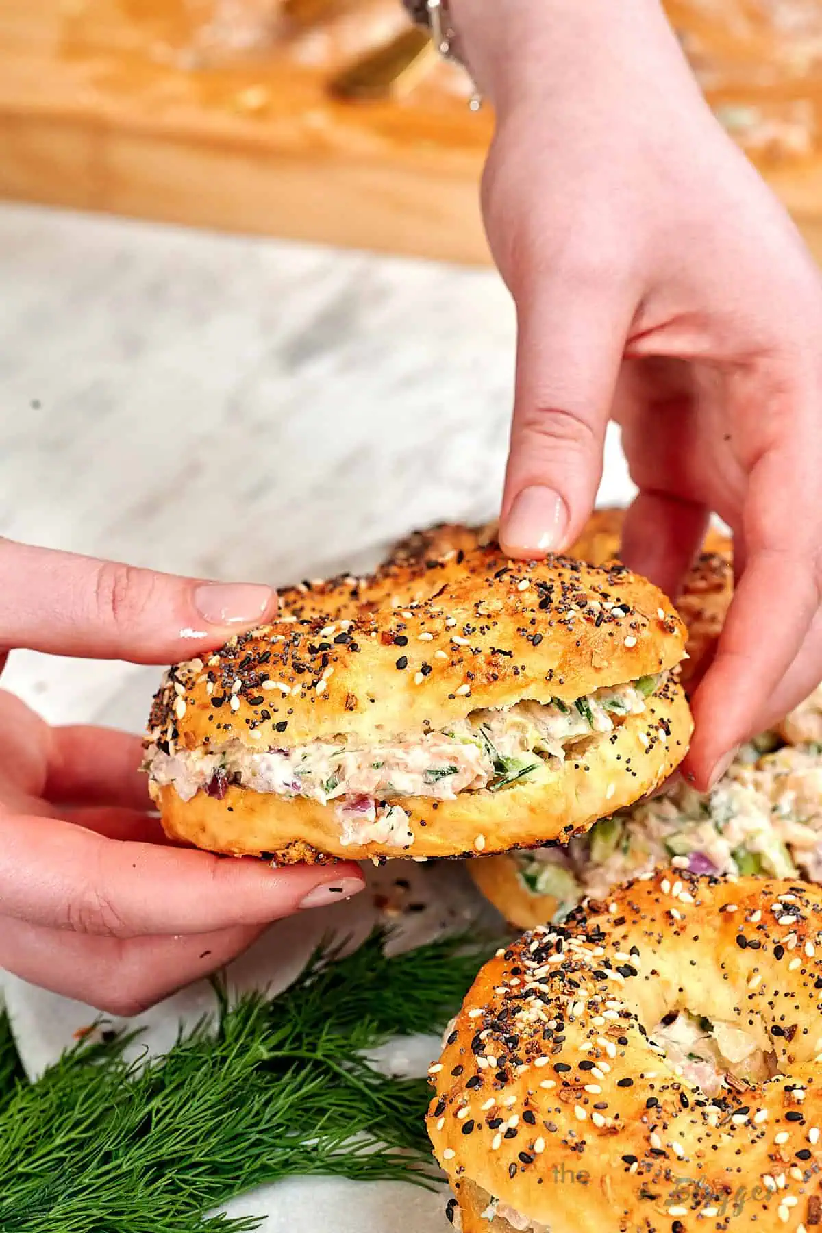 Viral Smoked Salmon Chopped Salad Bagel 9 Holding a viral smoked salmon chopped salad bagel