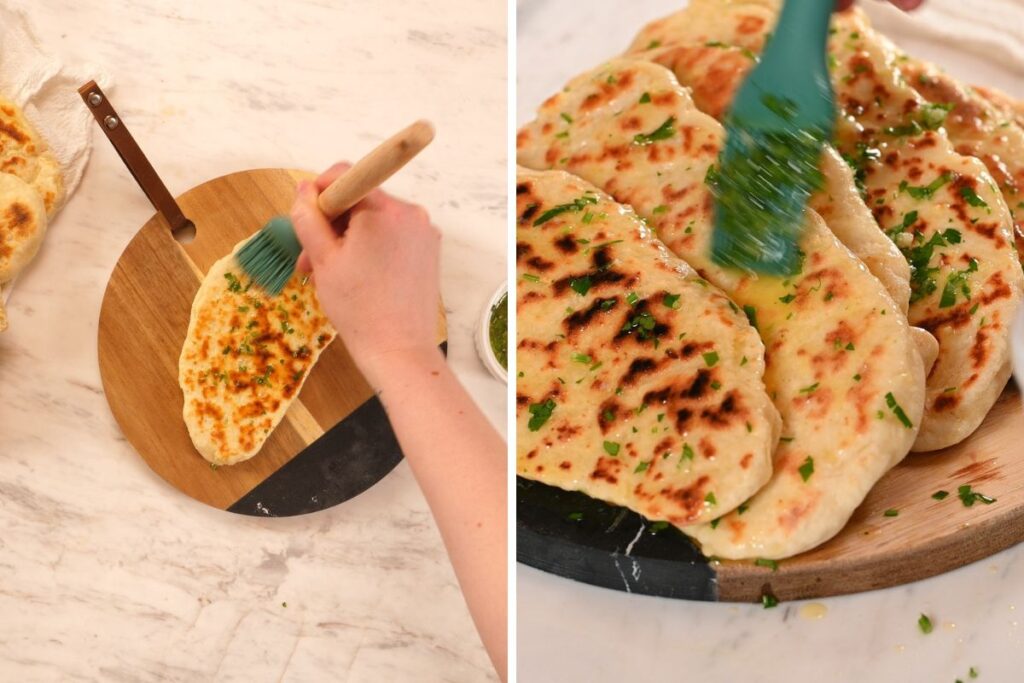 2-Ingredient Garlic Butter Naan 10 Brushing warm homemade naan with garlic butter on a wooden serving board.