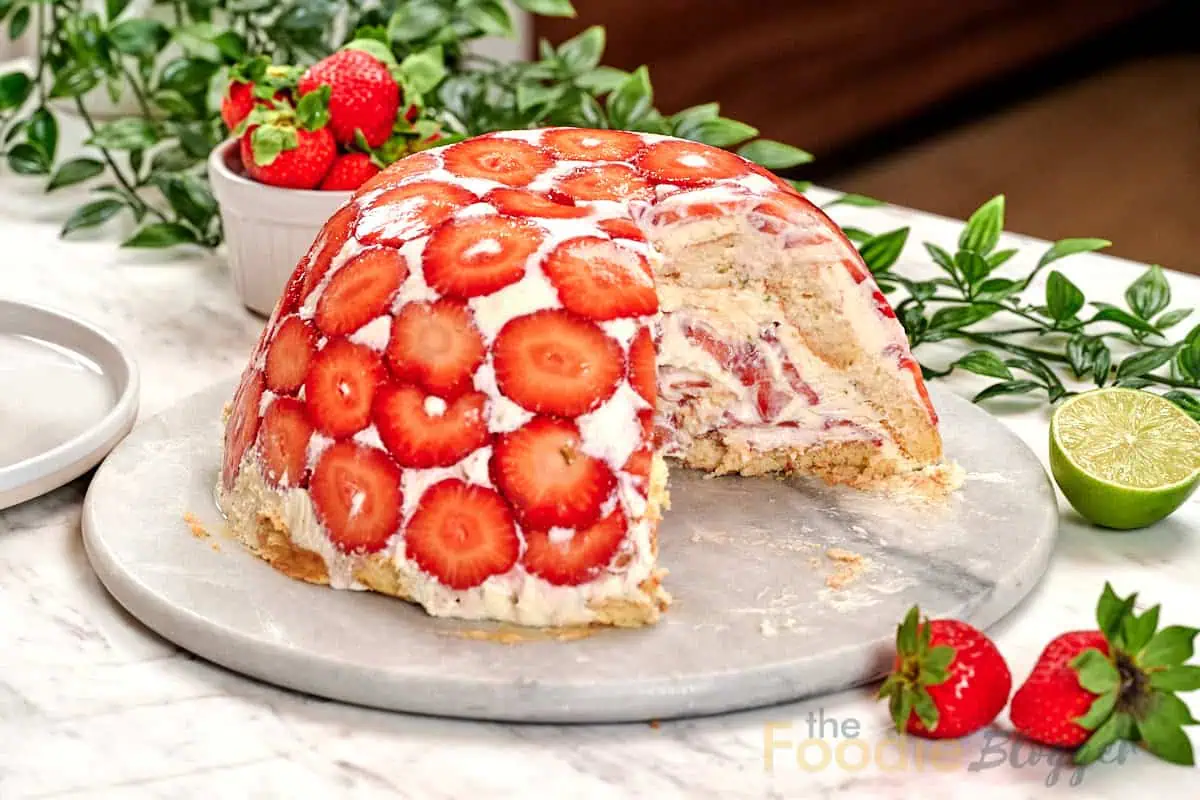 No-Bake Strawberry Lime Charlotte Cake 13 No-bake strawberry lime Charlotte cake topped with fresh strawberry slices and filled with layers of creamy lime filling, strawberries, and ladyfingers.
